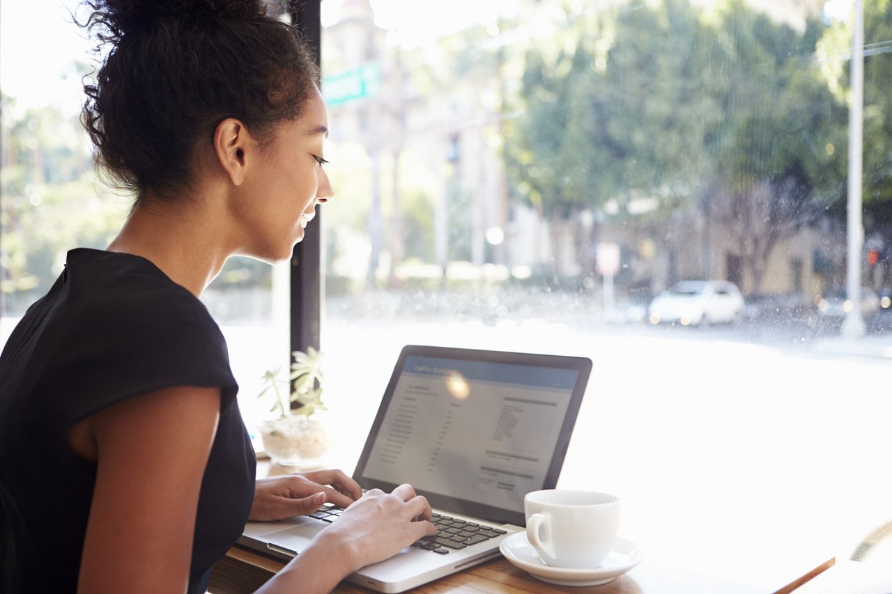 business woman working on laptop in a coffee shop