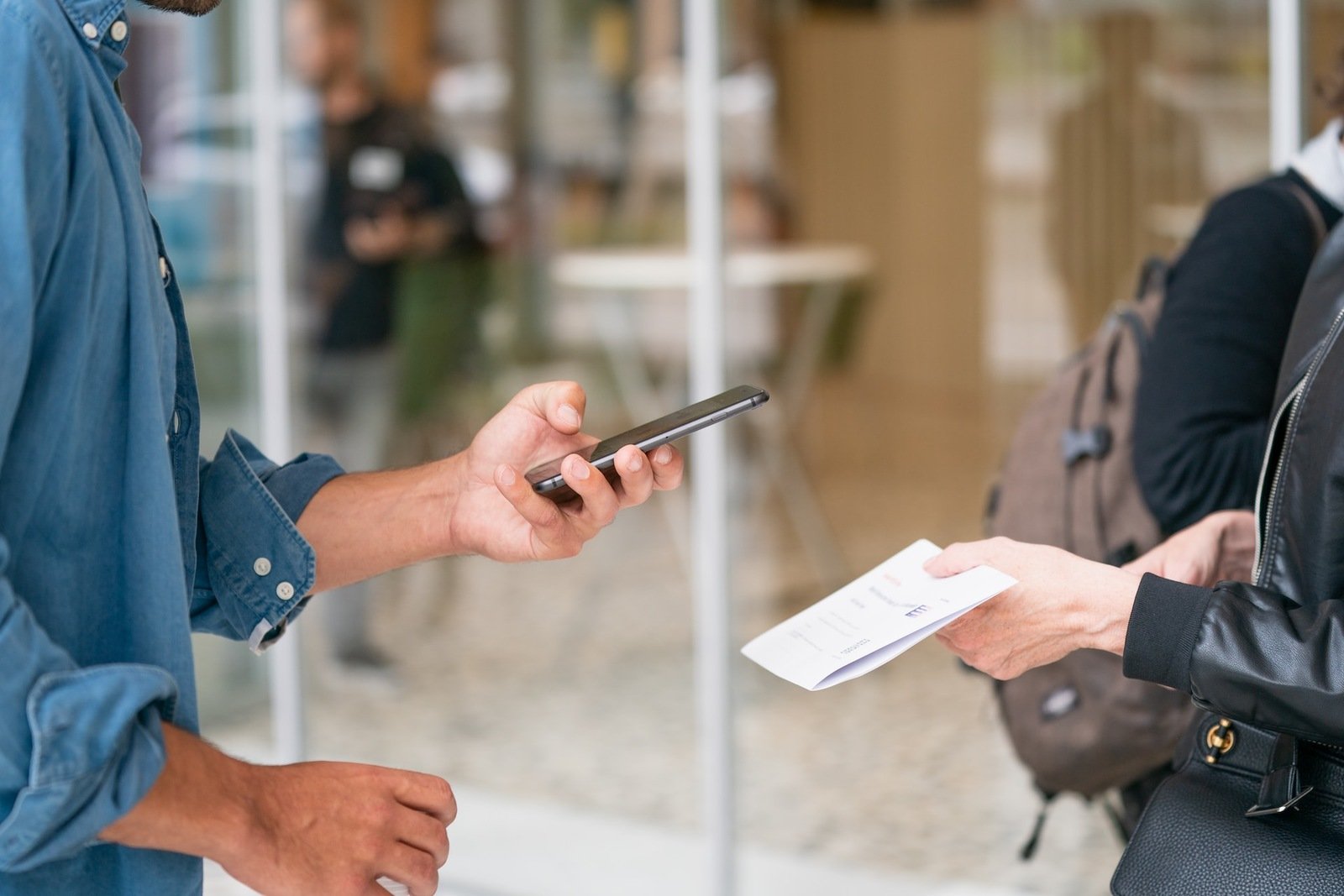 man scanning a QR code from another phone