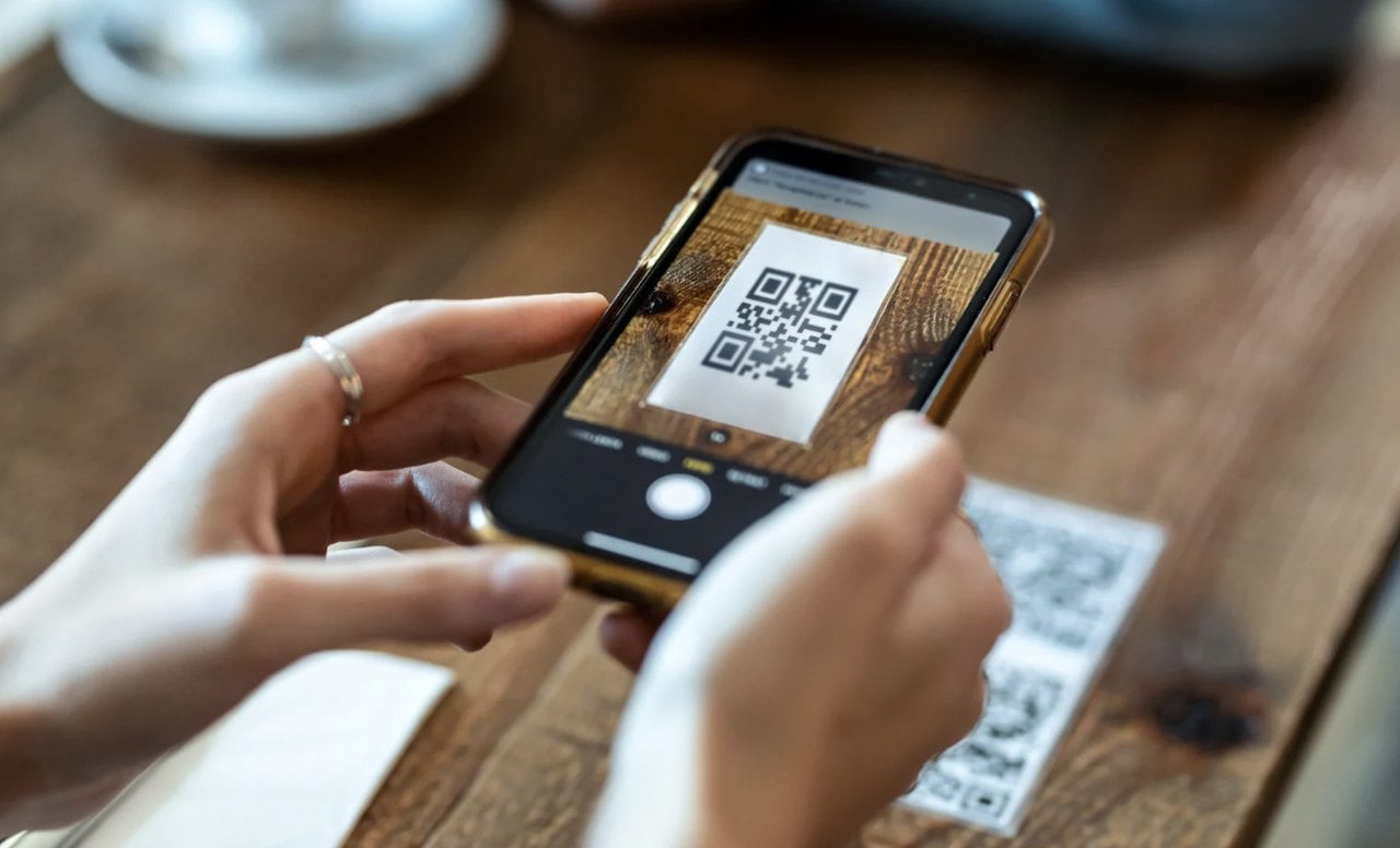 hands scaning a QR code with a smartphone