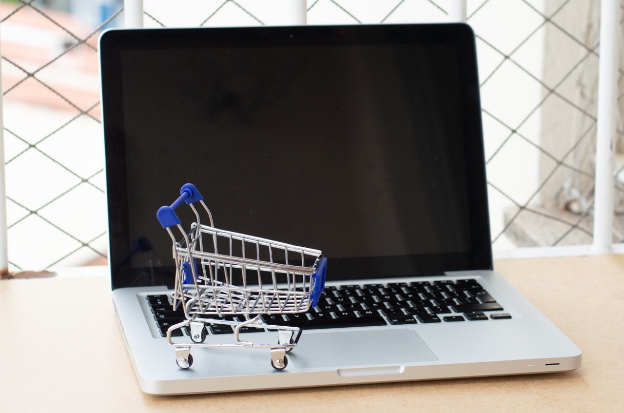 miniature shopping cart on laptop keyboard