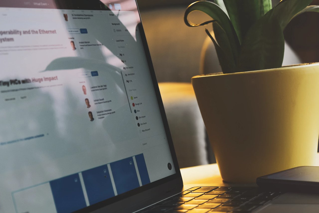 laptop and a yellow plant pot stock image on a dim light