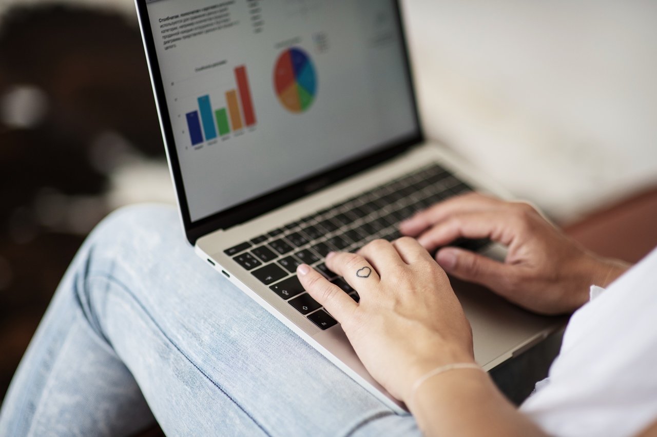 woman checking reports and data on laptop