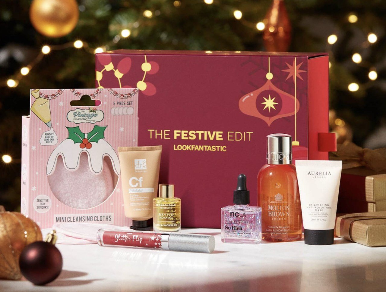 christmas special edition products like parfumes and creams with their boxes behind on a Christmas-related setting