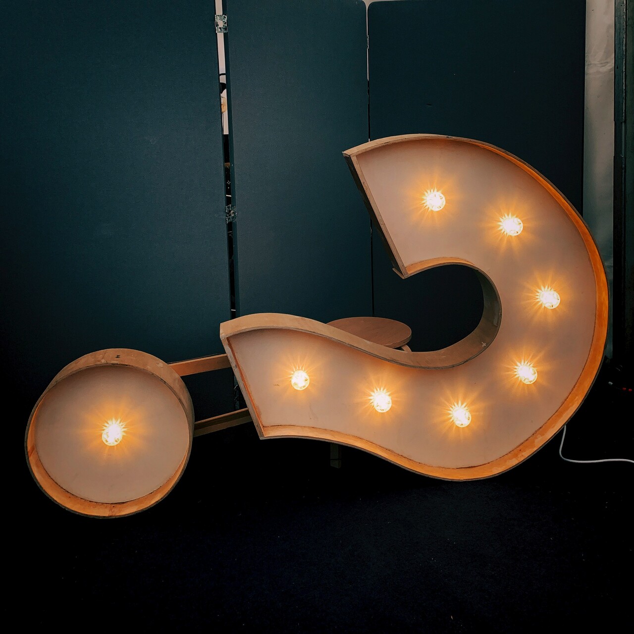 a question mark with lights standing