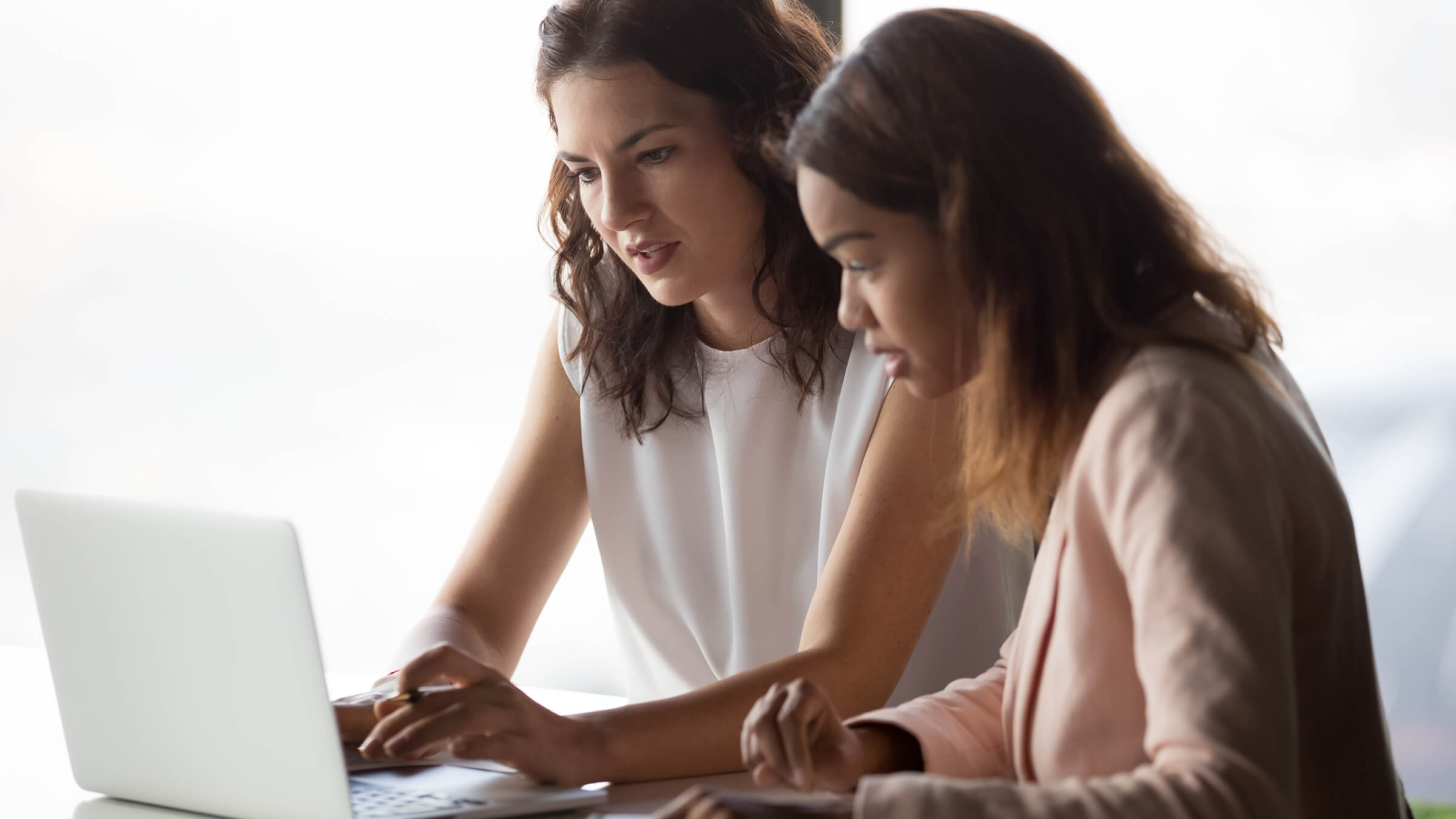 Two people working on laptop