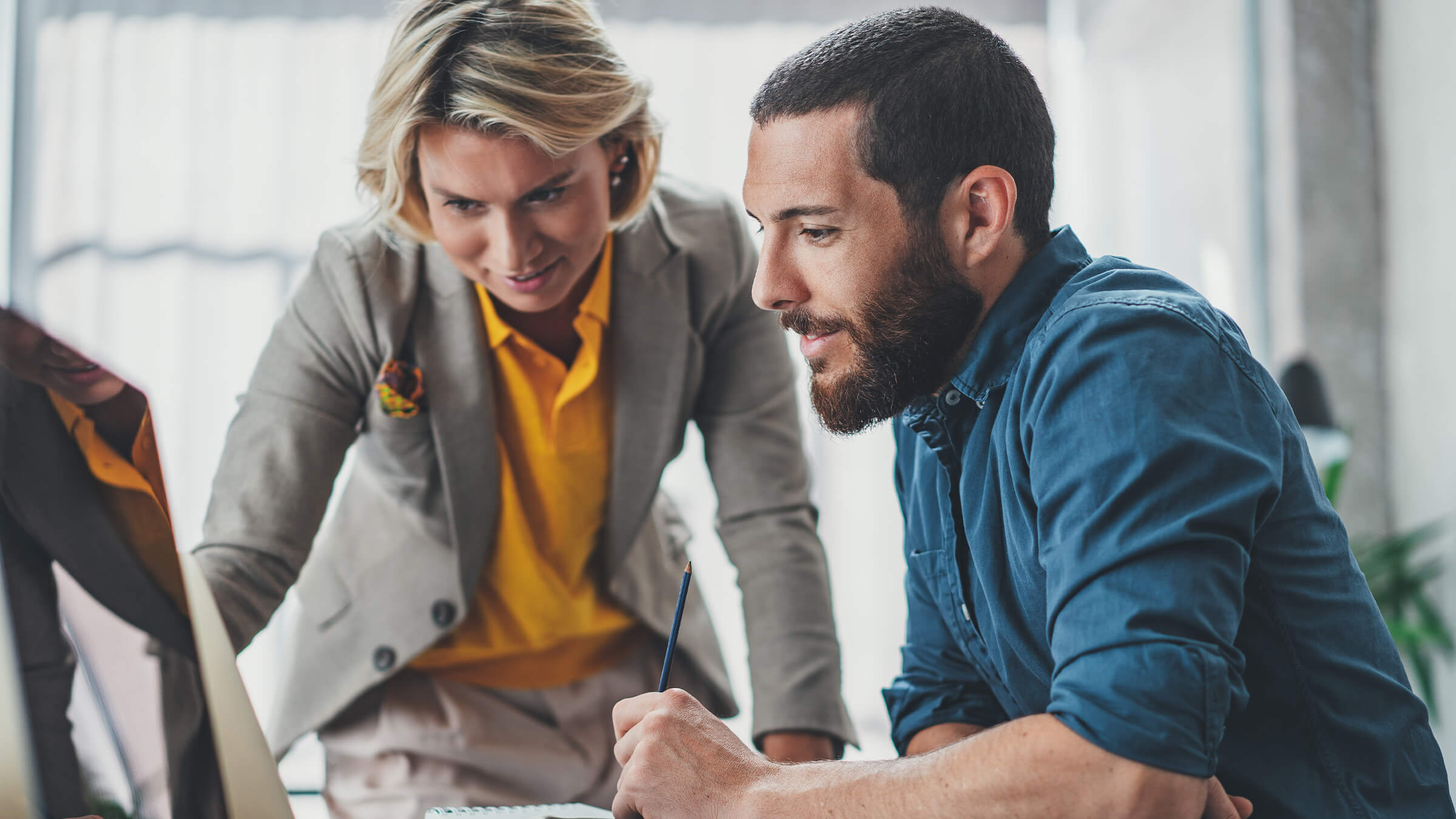 Two people reviewing statistics