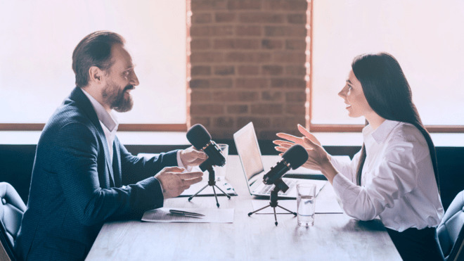 two professionals having a conversation with microphones