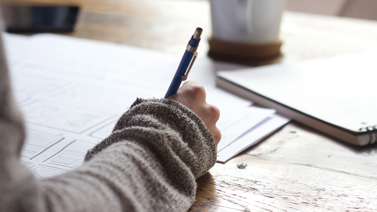 Person writing in notebook