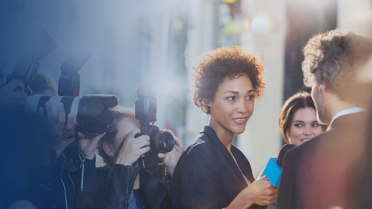 woman with microphone interviewing man