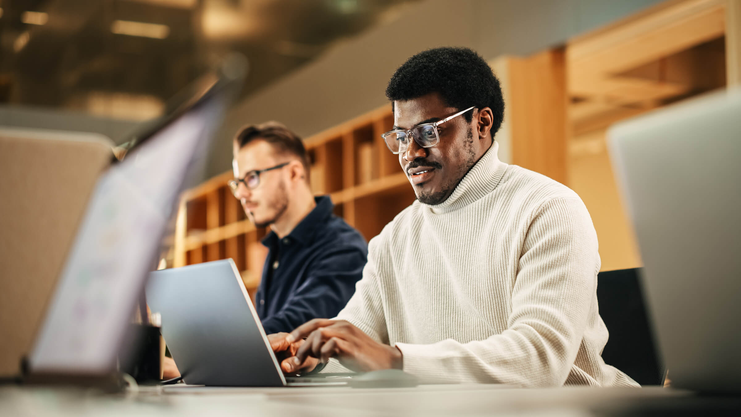 Two People working on laptops