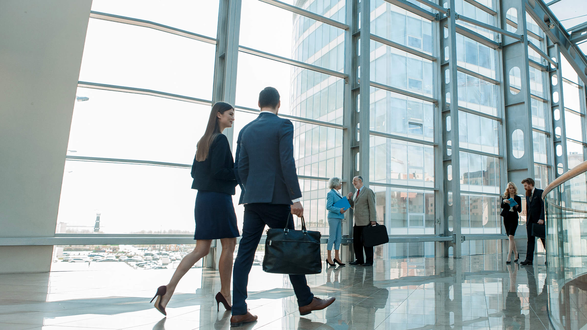 Two people walking through office