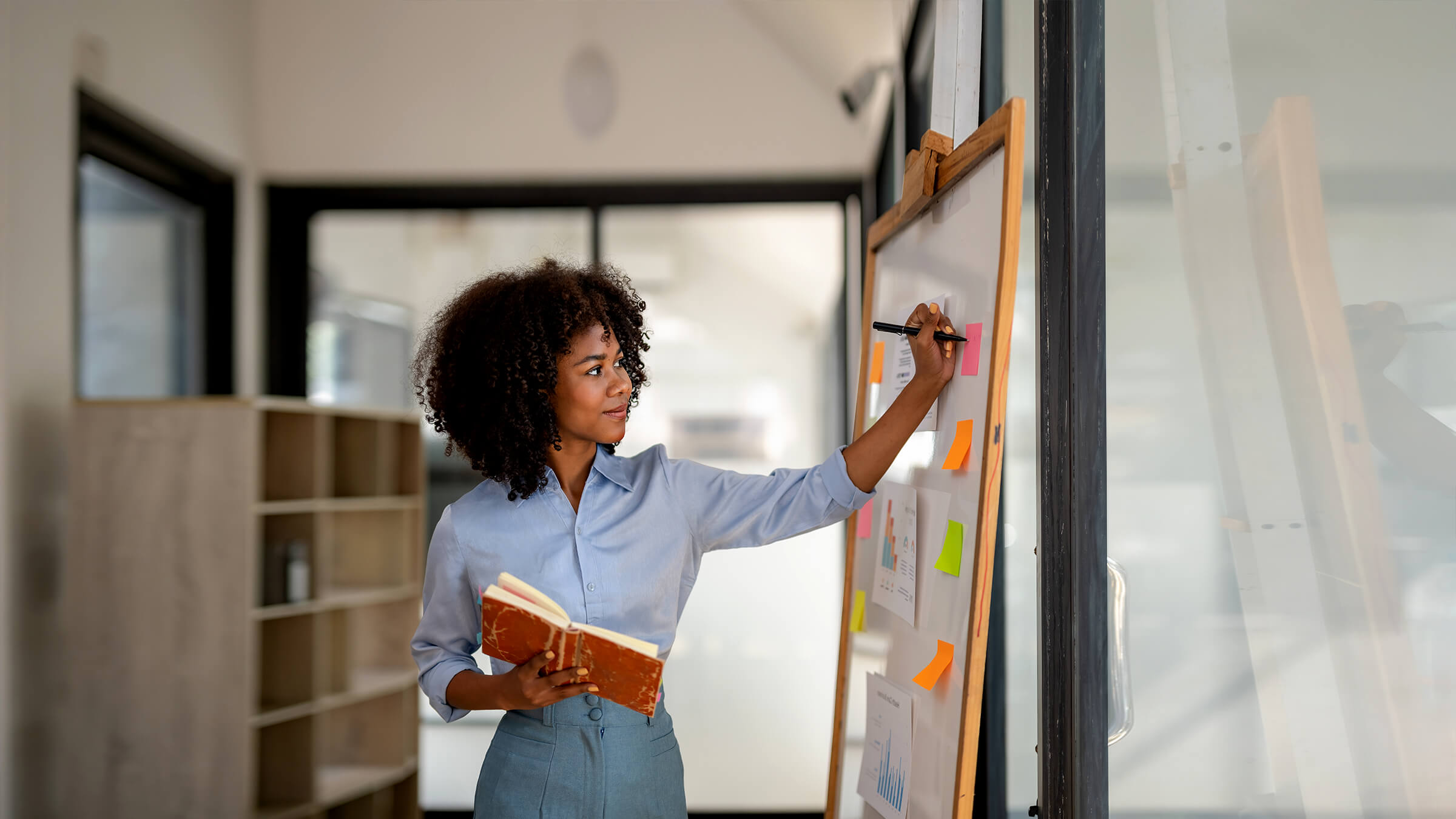 Young woman writing on whiteboard