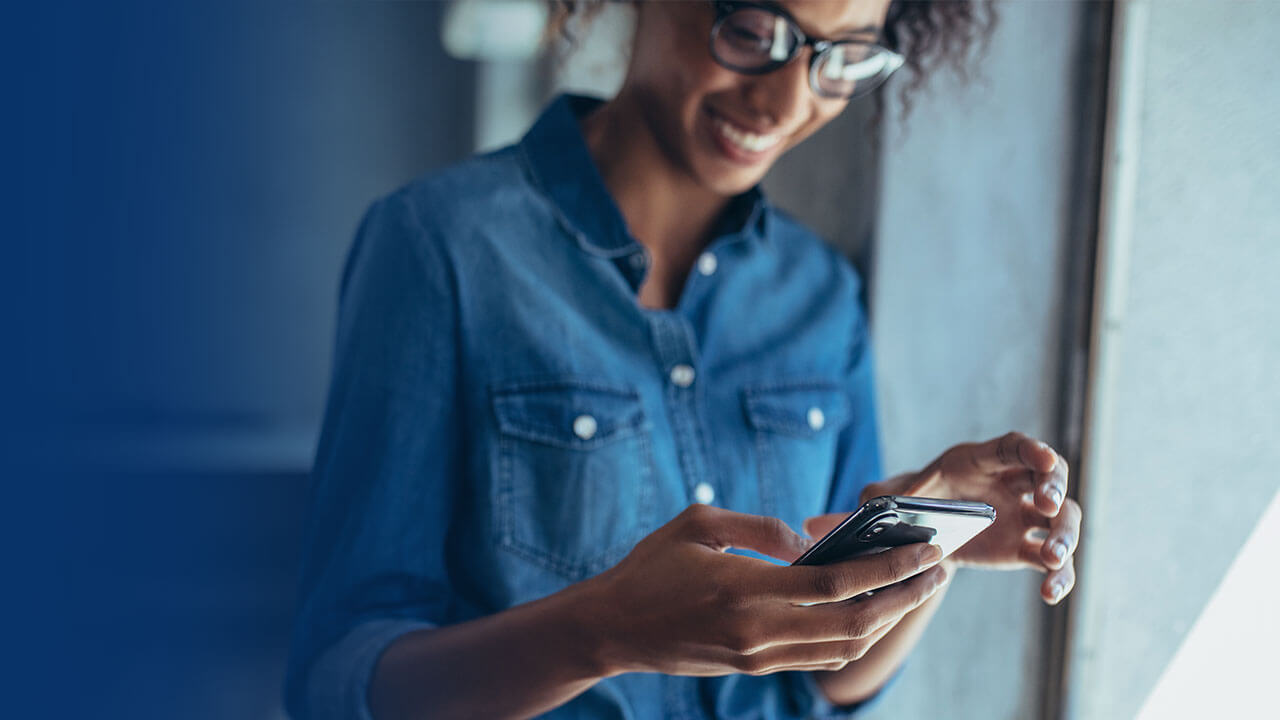 female standing holding mobile phone